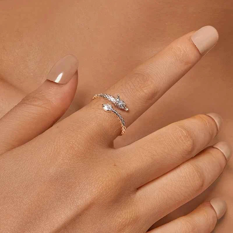 Hand wearing a slender silver dragon ring, showing its size in a real styling photograph.