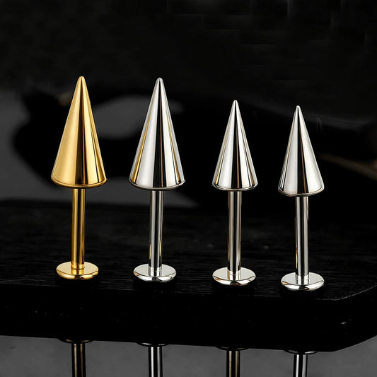 Gold and silver titanium cone spike labrets compared on black background