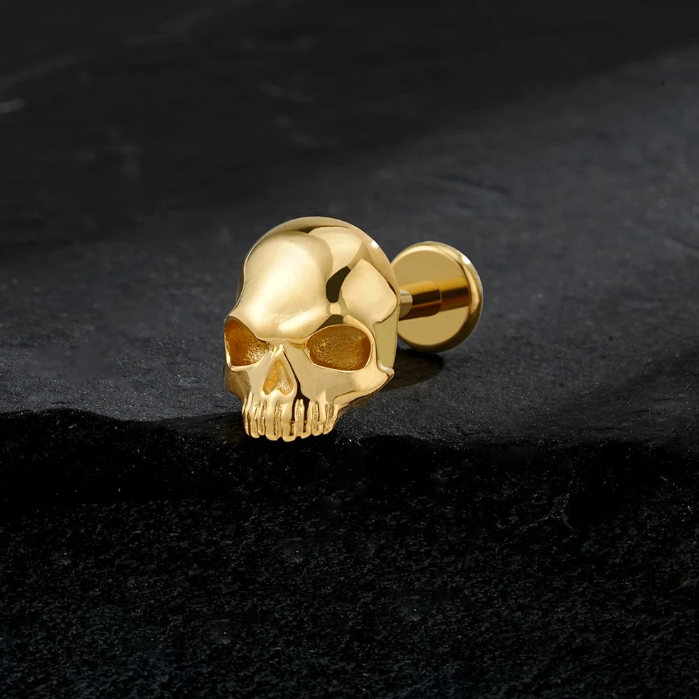 Gold-tone titanium skull 16G flat back labret stud close-up
