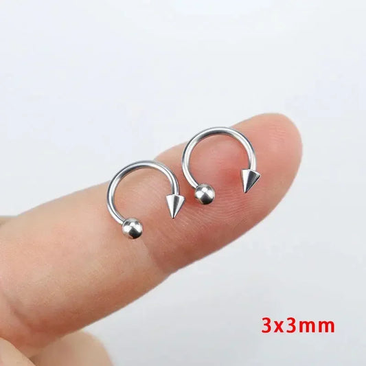 Silver-tone titanium horseshoe septum ring with one spike and one ball end